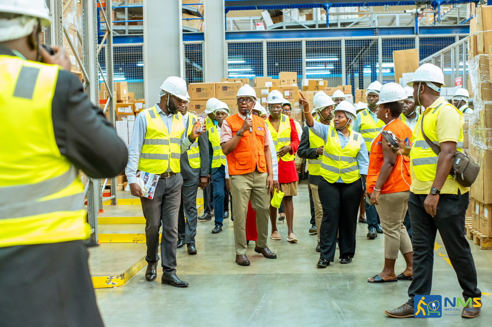Government communicators with NMS General Manager Dr. Moses Kamabare during a tour of the warehouse at the Kajjansi office.